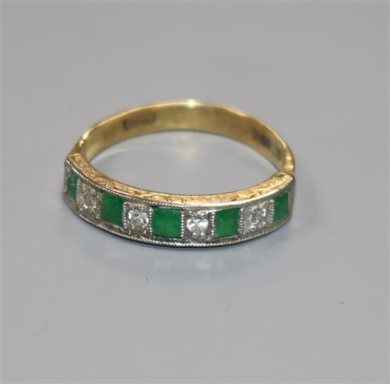 A modern 18ct gold, emerald and diamond nine stone half hoop ring, size N.
